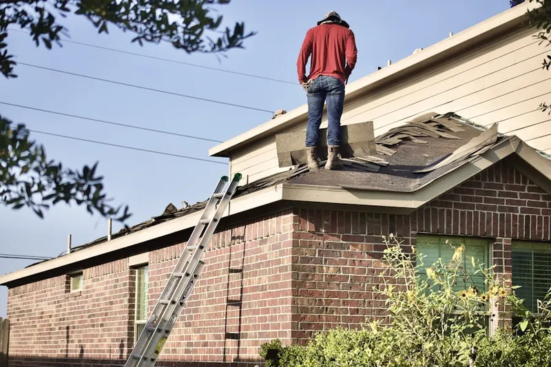 Professional roofer working on a residential roof in New Upsala